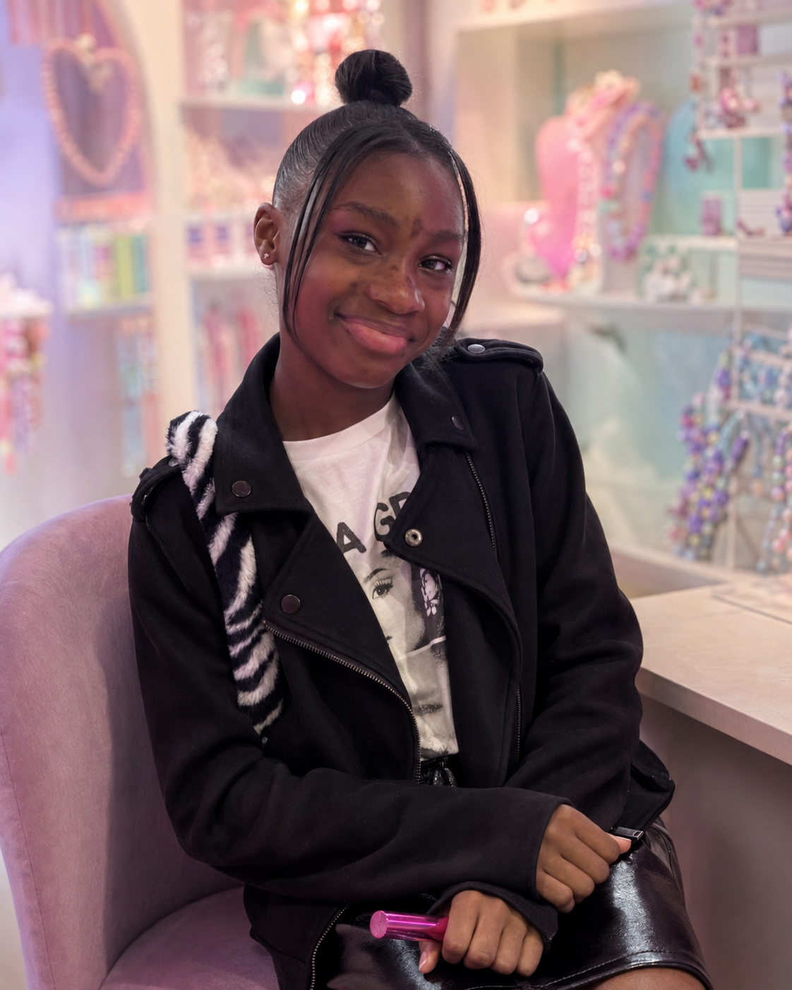 Neriah, founder of Riah's Charms, in a pastel jewellery boutique
